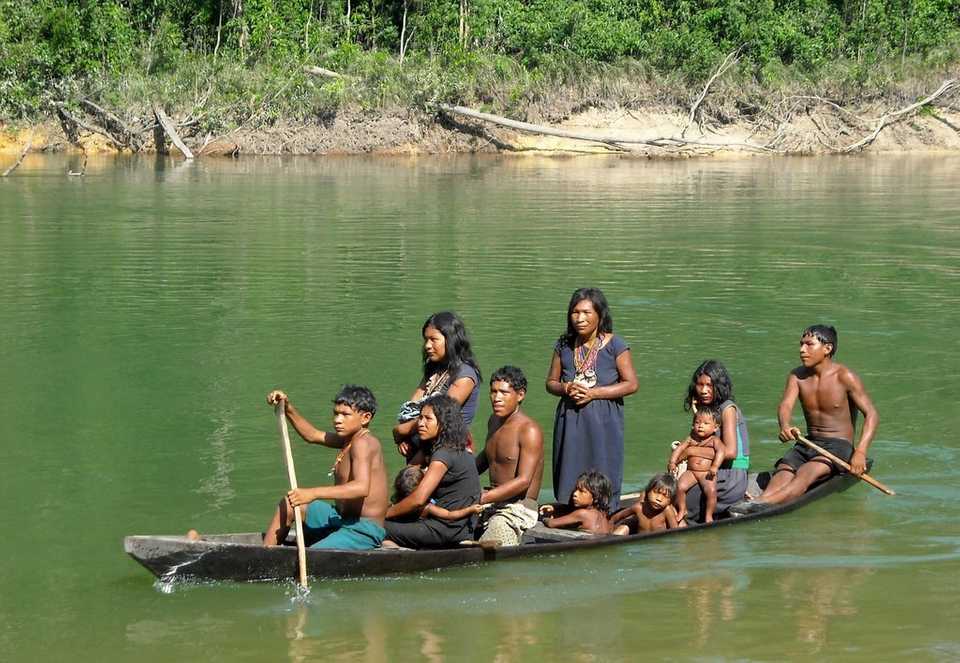 Pirahã people on a canoe.